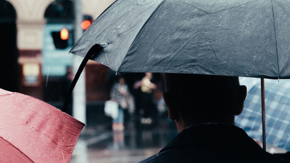 Two people under an umbrella