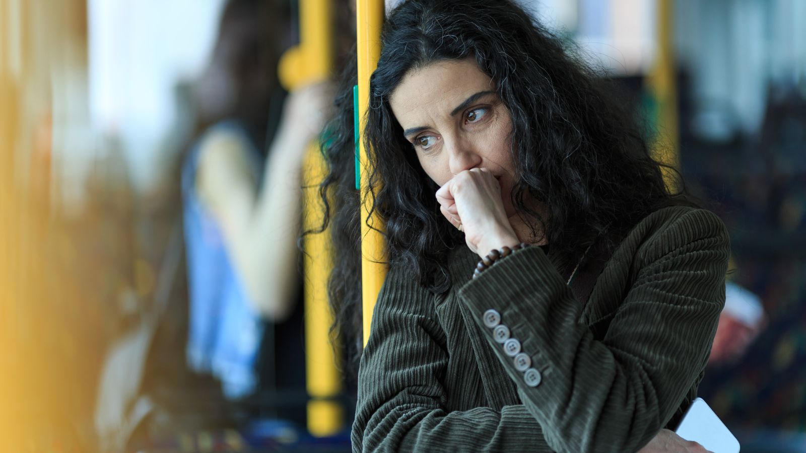 A woman standing up on a train